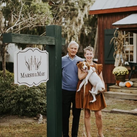 cople standing outside with their dog