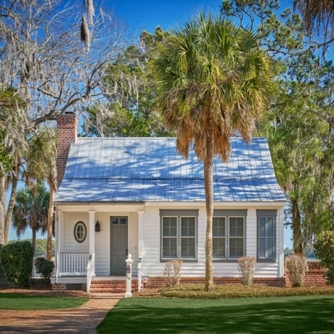 small cottage with palm trees