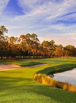 golf course at dusk with a pond and sand bunkers in view